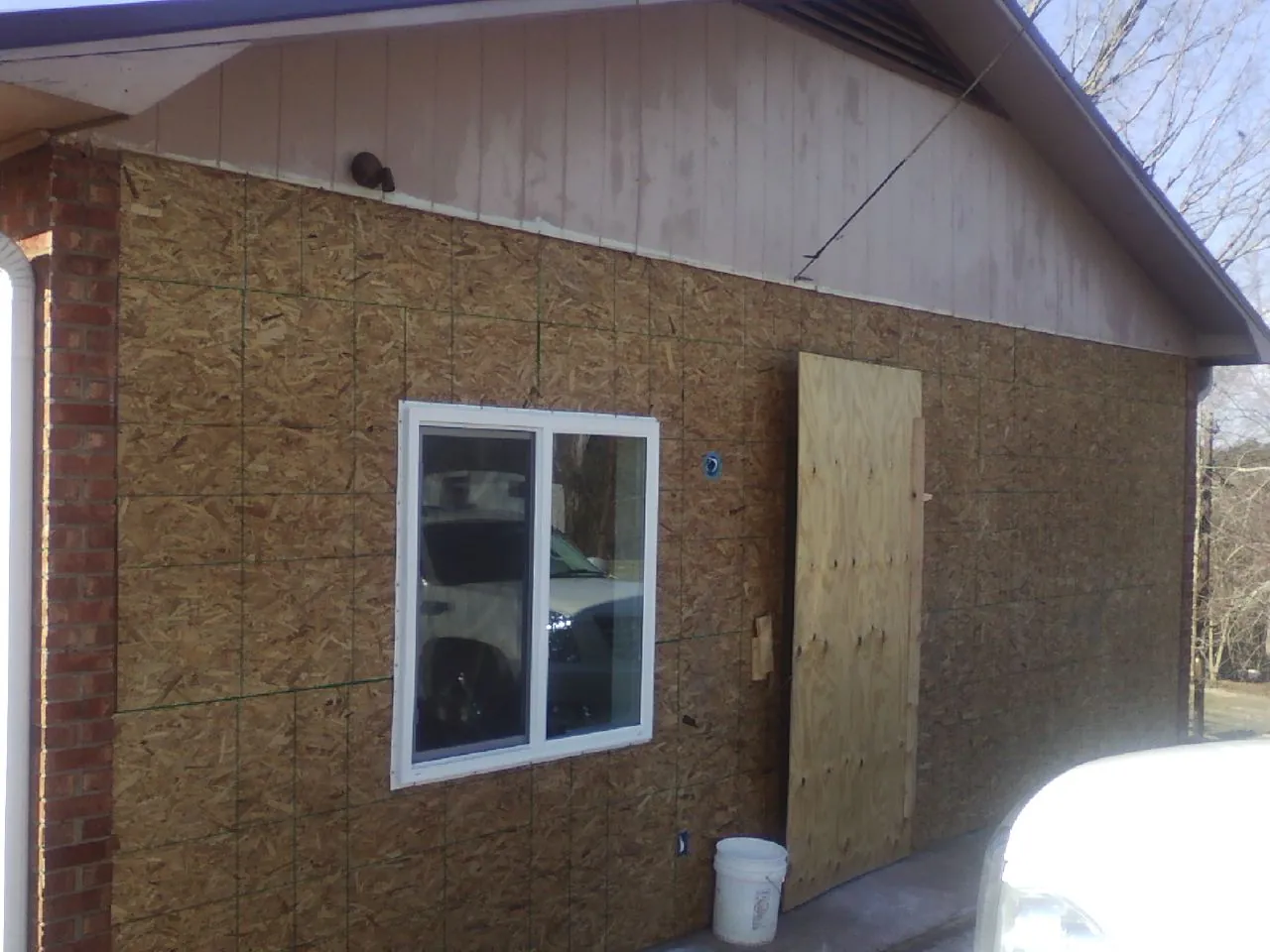 OSB sheathing on a garage addition wall before siding in Prairie Lea