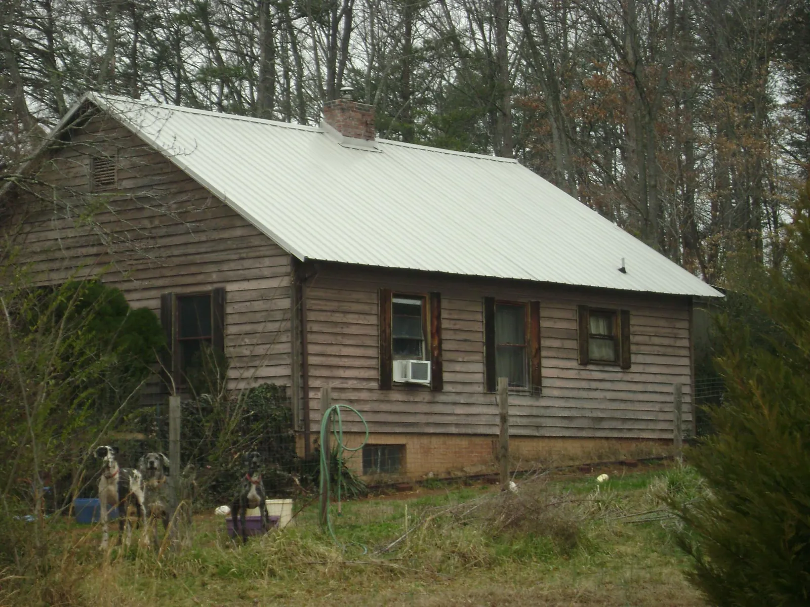 White metal roof on an old wood sided farmhouse, from a Metal Roof Installation job in Prairie Lea